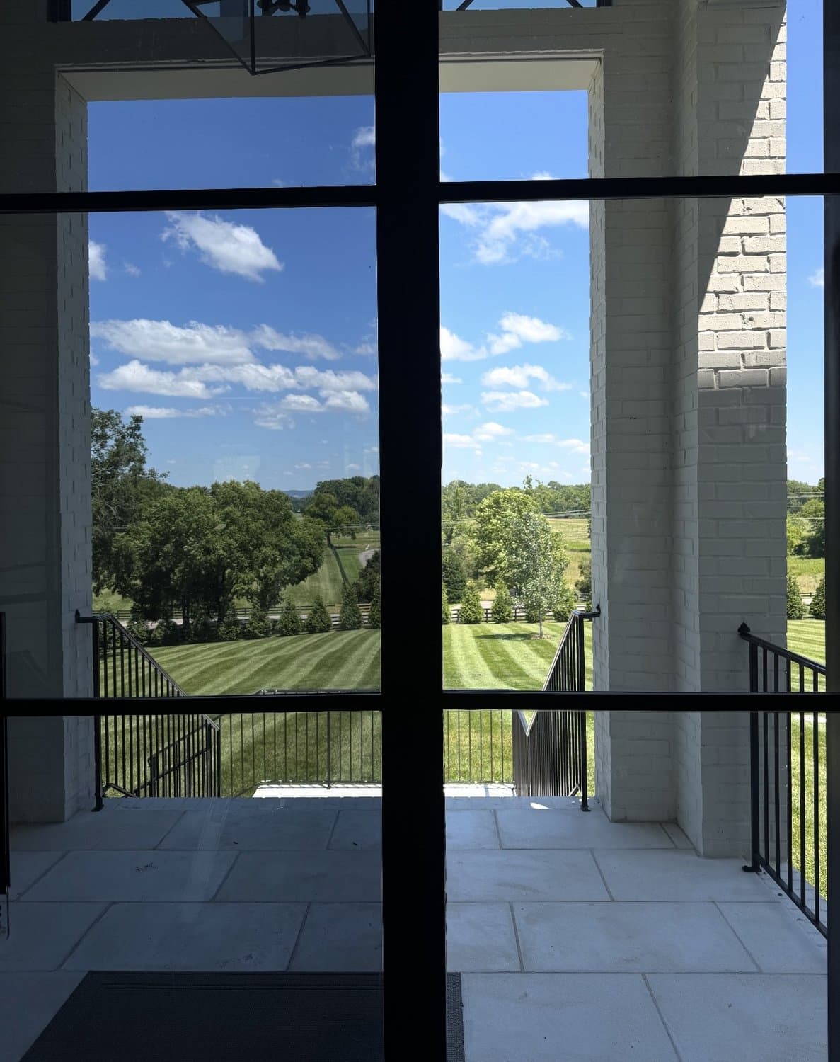 Two-story tinted windows with a clear view of the grounds
